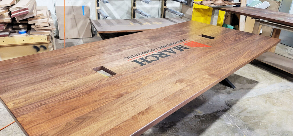 http://Walnut%20Conference%20Table%20With%20CNC%20Logo%20And%20Cable%20Grommets%202
