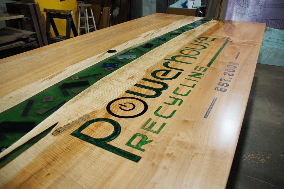 large conference river table with cnc logo embedded electronics custom wood furniture